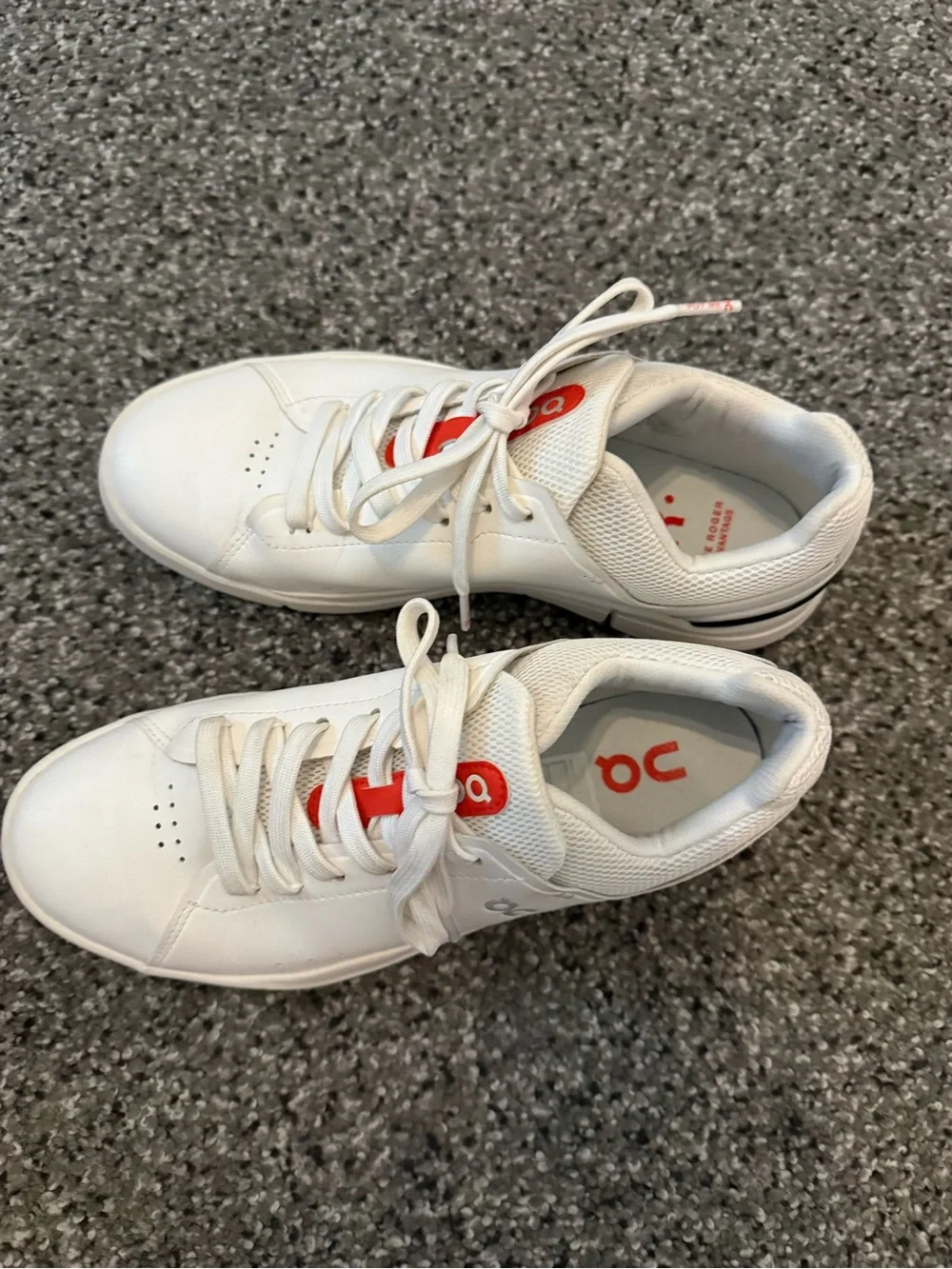On Running White Sneakers with Red Accent